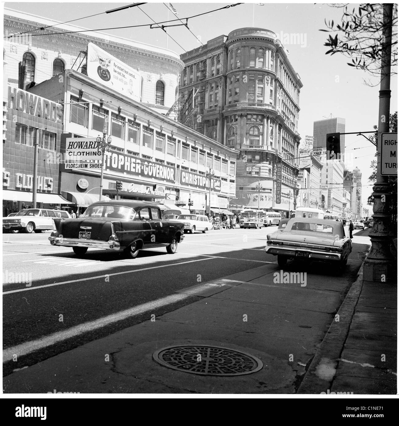 USA, 1950s. Summertime, and a street in San Francisco, California, showing shops, signs and buildings. Stock Photo