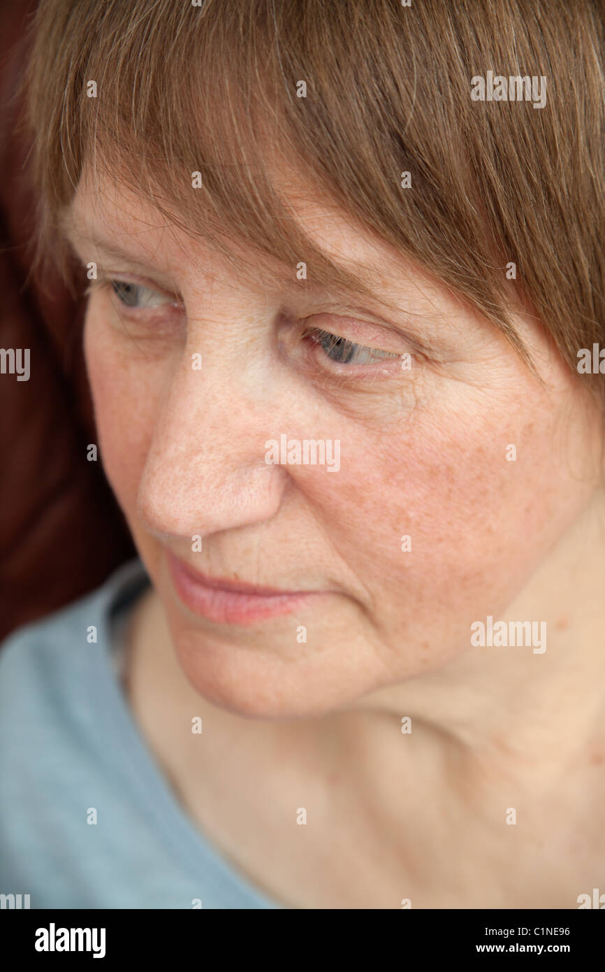 Portrait of a senior woman relaxed in an armchair at home Stock Photo