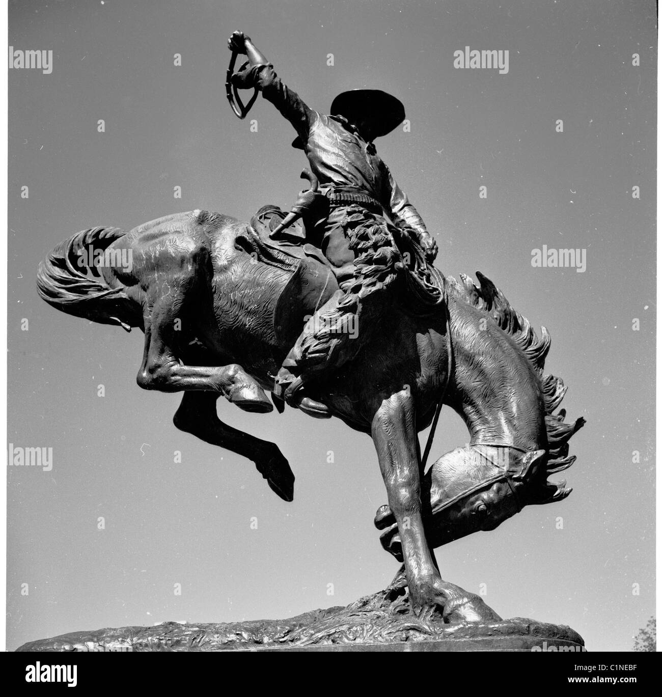 America, 1950s. View from below of the bronze statue of the famous Indian hunter Buffalo Bill on his Bucking Bronco, Denver. Stock Photo