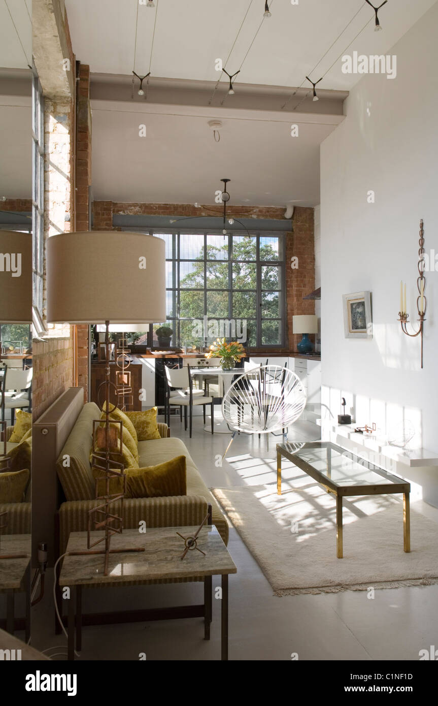 Open plan living space in warehouse conversion with Crittal windows