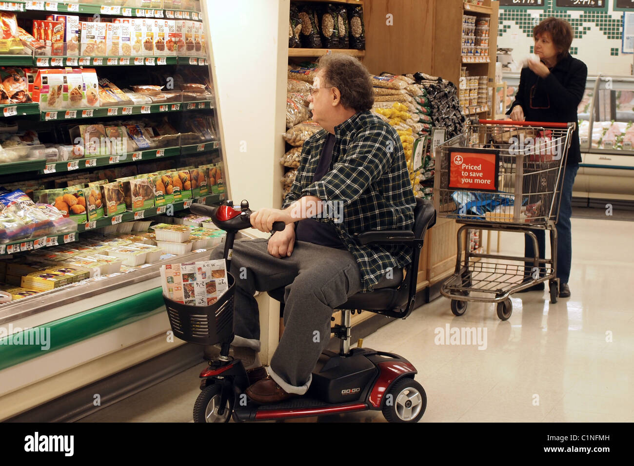 Disabled man in his mobility transport shopping for food at a grocery