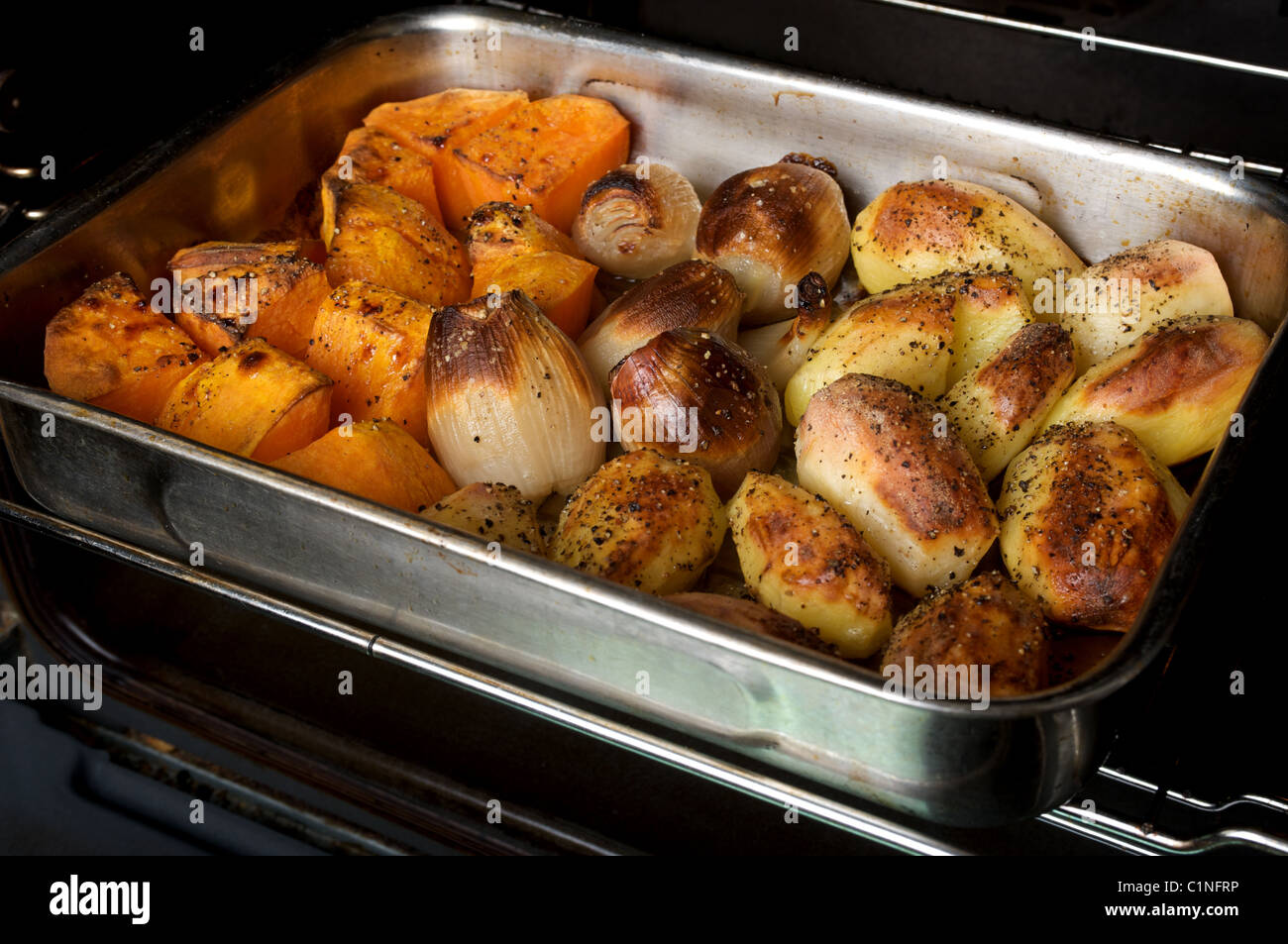Vegetables roasting in electric oven Stock Photo Alamy