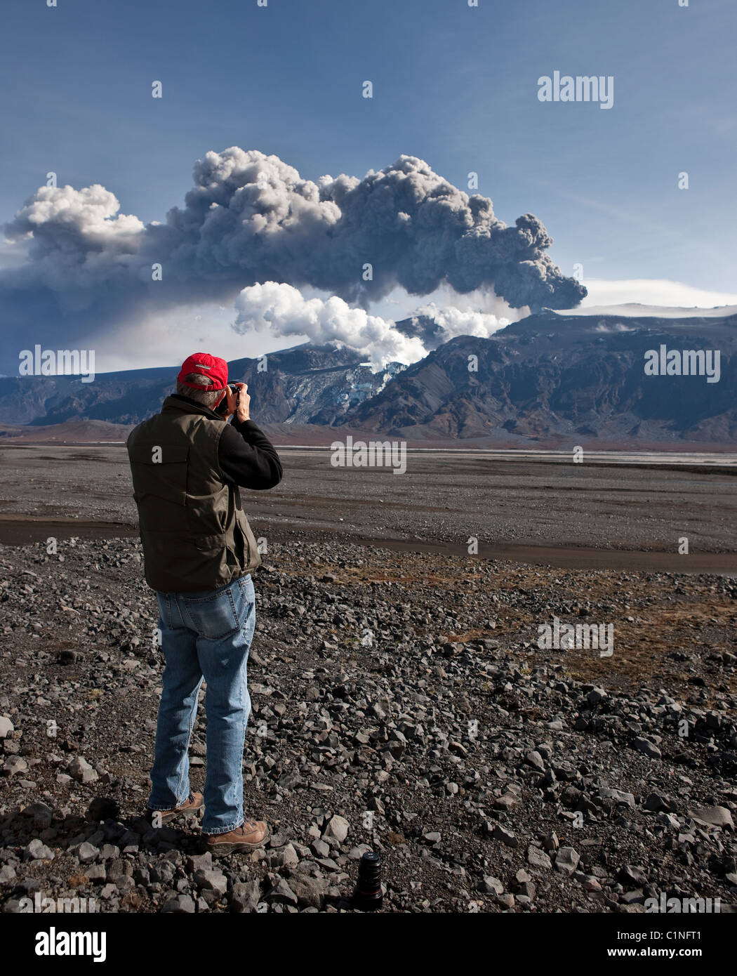 Tourist photographing Eyjafjallajokull volcano erupting, Iceland   March 2010 Stock Photo