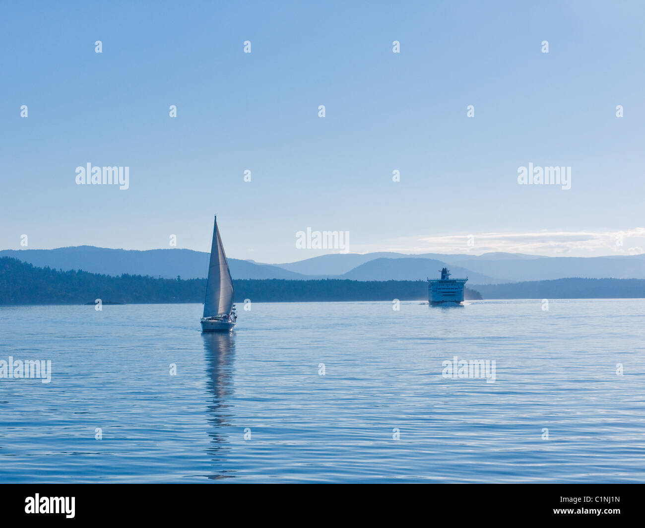 Sailboat and ferry, Gulf Islands, British Columbia, Canada Stock Photo