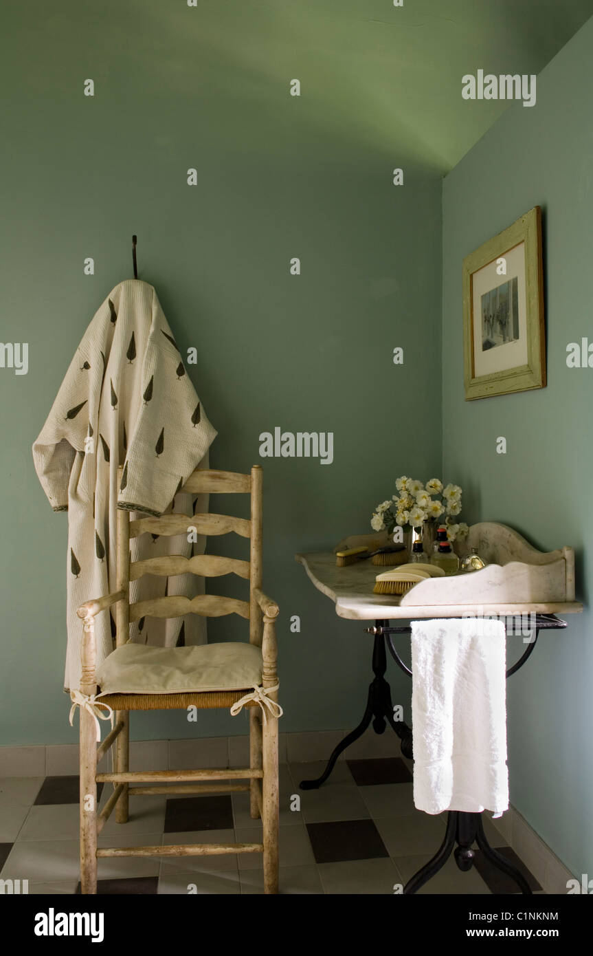 Wooden chair and marble washstand in room corner Stock Photo