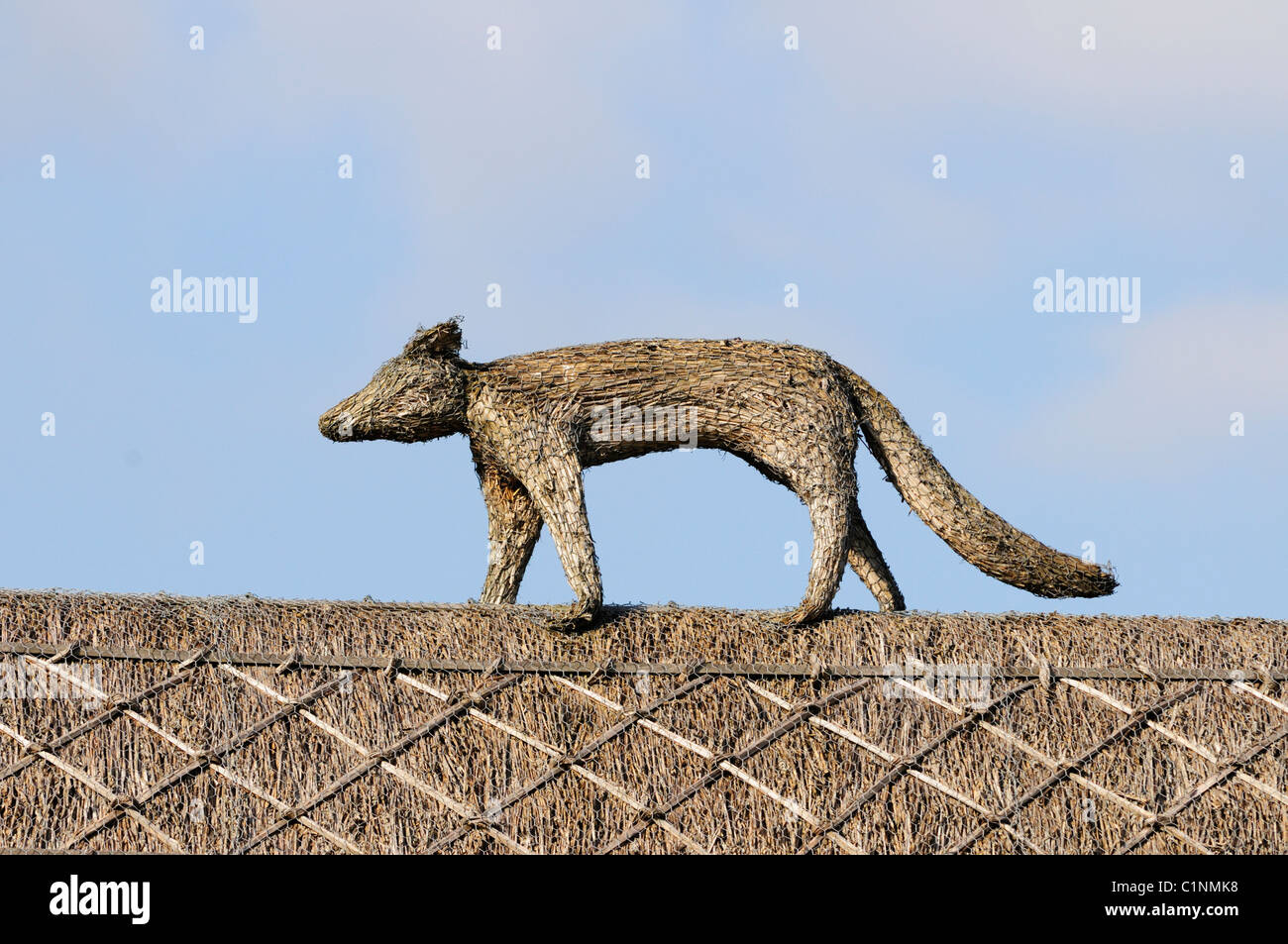 A Thatched Roof with Fox Sculpture, Haslingfield, Cambridgeshire, England, UK Stock Photo
