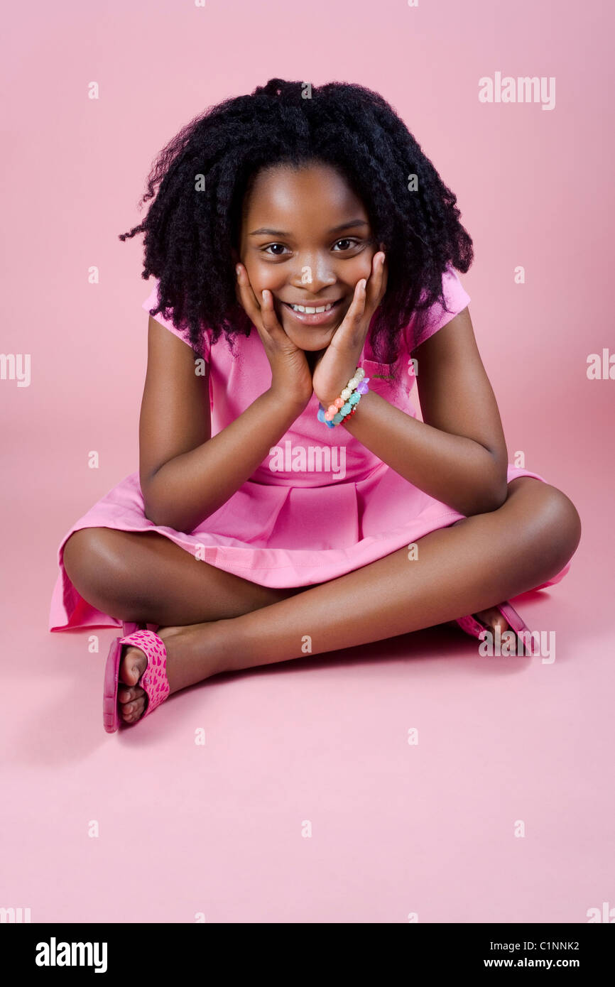 young girl with hands on face smiling Stock Photo - Alamy