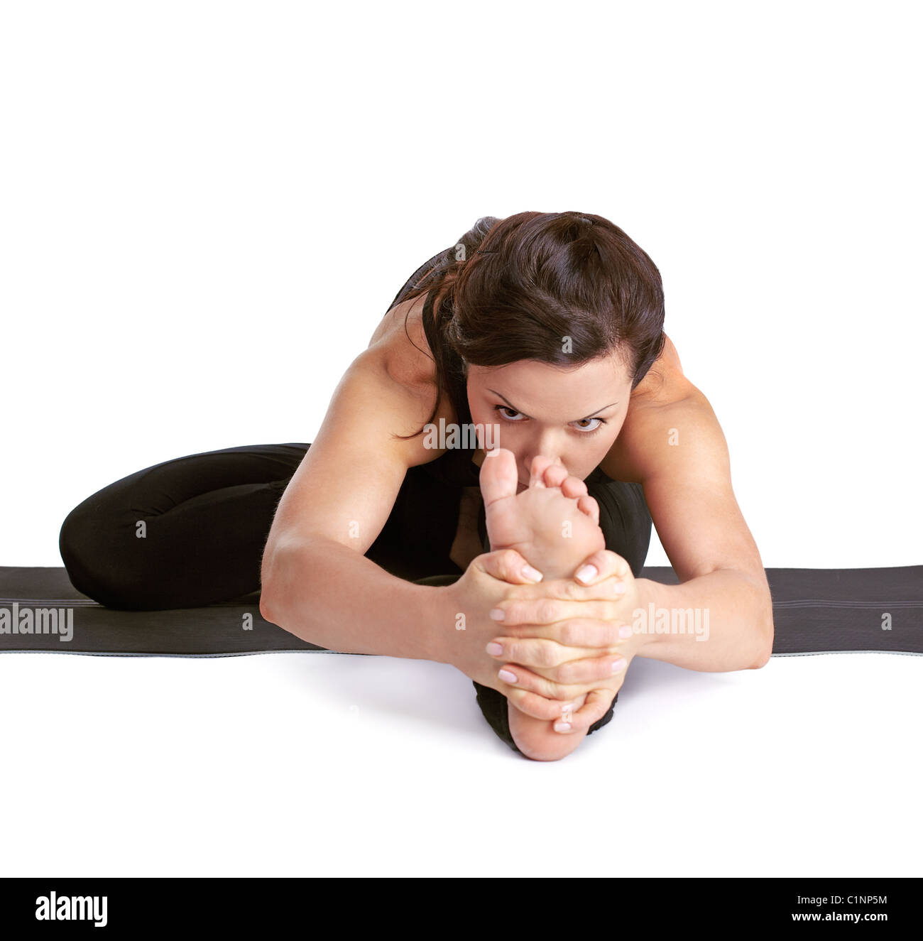 full-length portrait of beautiful woman working out yoga excercises Janu shirshasana pose on fitness mat Stock Photo