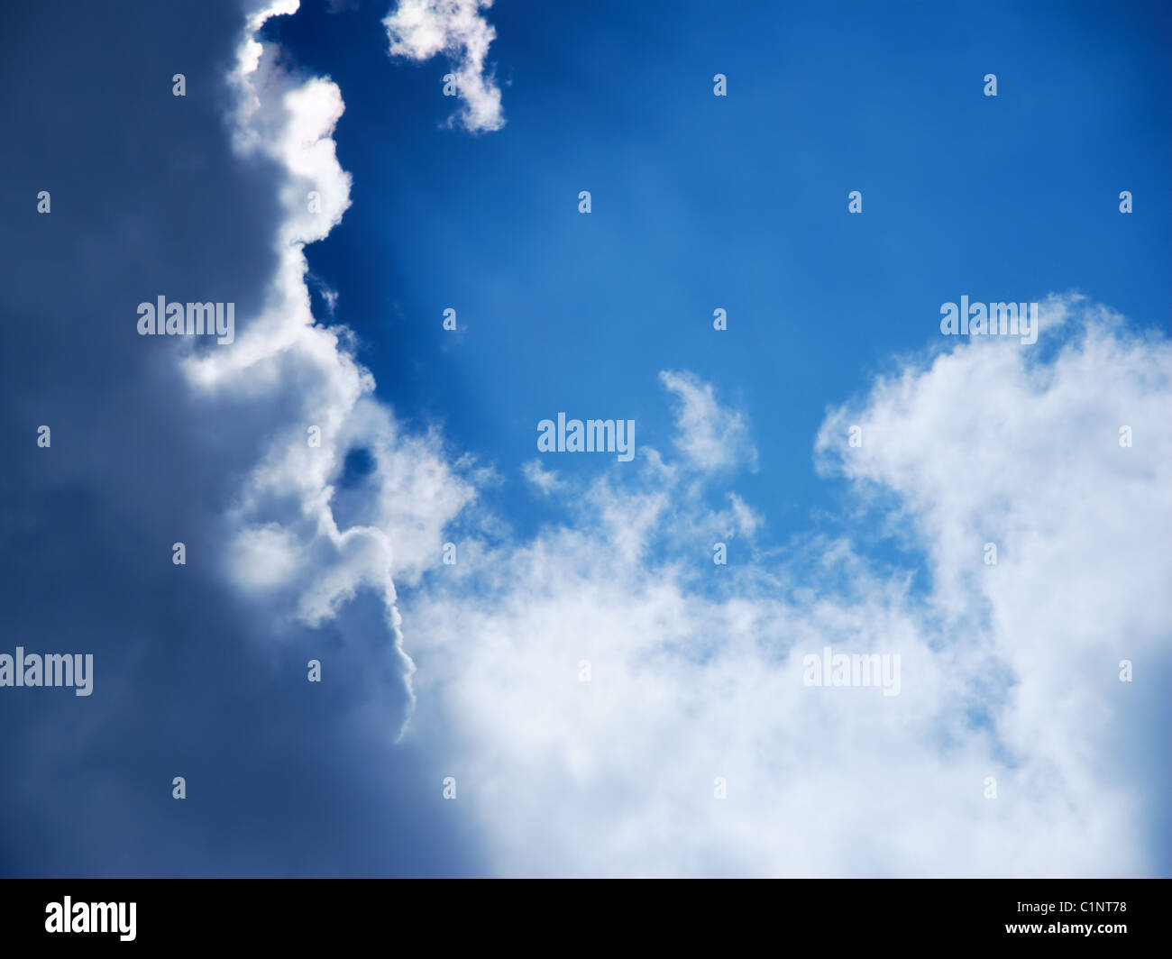 Moody sky with clear blue surrounded by dark clouds Stock Photo