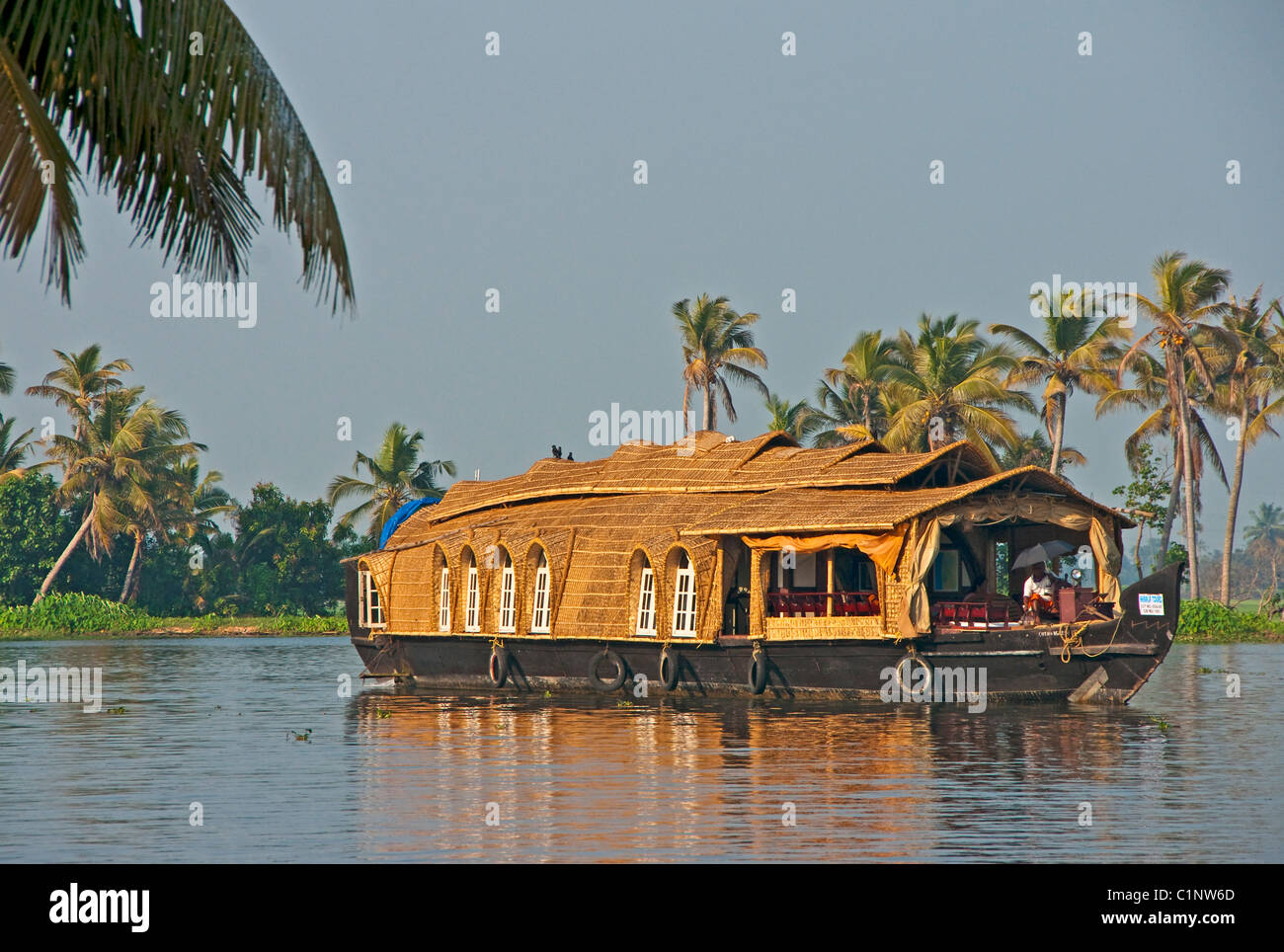Houseboat cruising the tropical Kerala Backwaters on the Malabar coast of South India. Stock Photo