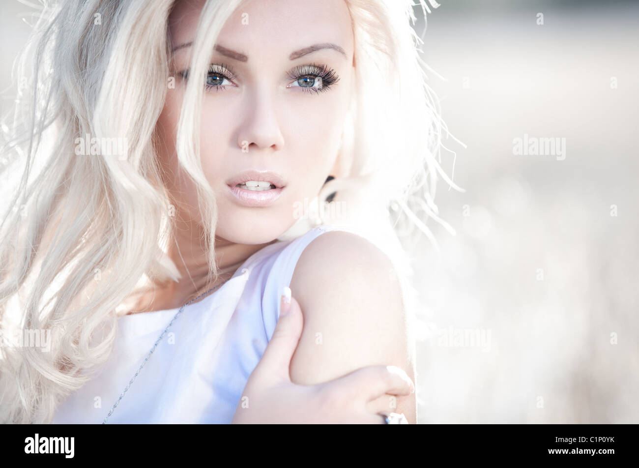 Young woman outdoors portrait. Bright white colors Stock Photo - Alamy