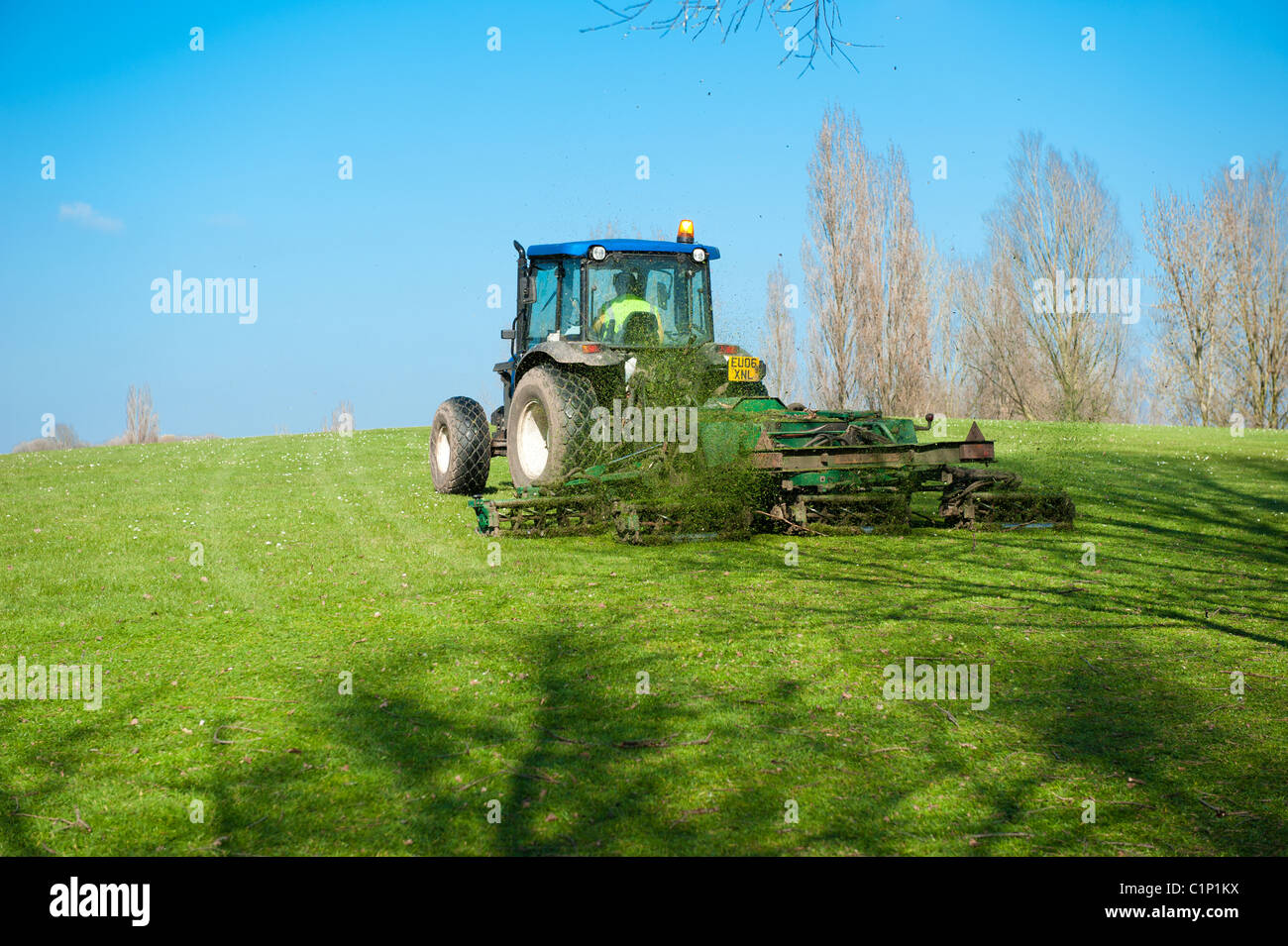 A council tractor cutting the grass in a public park. Stock Photo