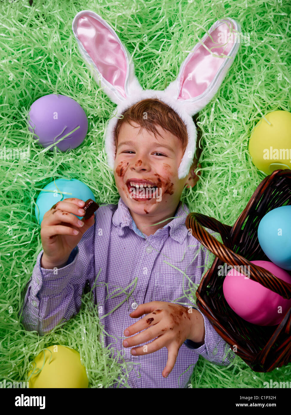 Boy indulging in chocolate eggs from the Easter Bunny Stock Photo