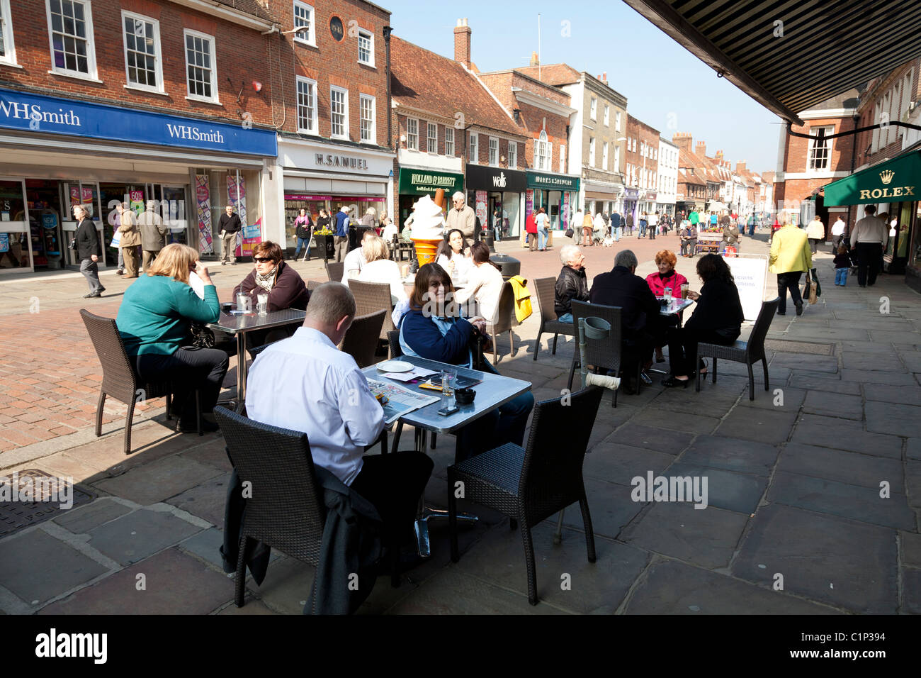 street tables outside coffee shop in pedestrianised town centre street Stock Photo