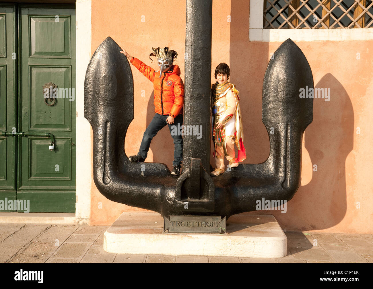 Children on holiday in Venice during the Carnival, playing on the anchor at the Naval Museum, Arsenale, Venice Italy Europe Stock Photo
