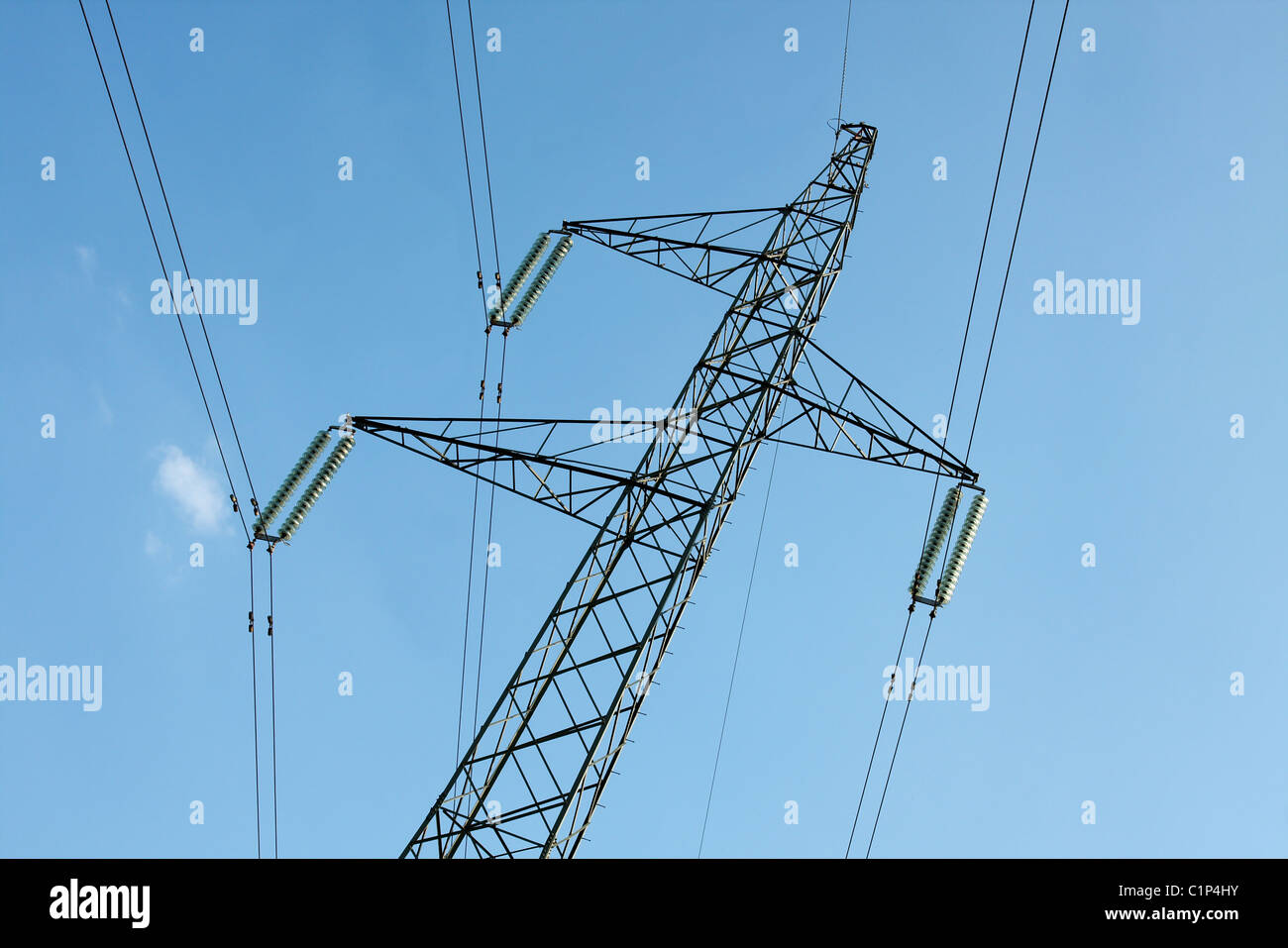 High voltage electricity pillar against clear blue sky Stock Photo - Alamy