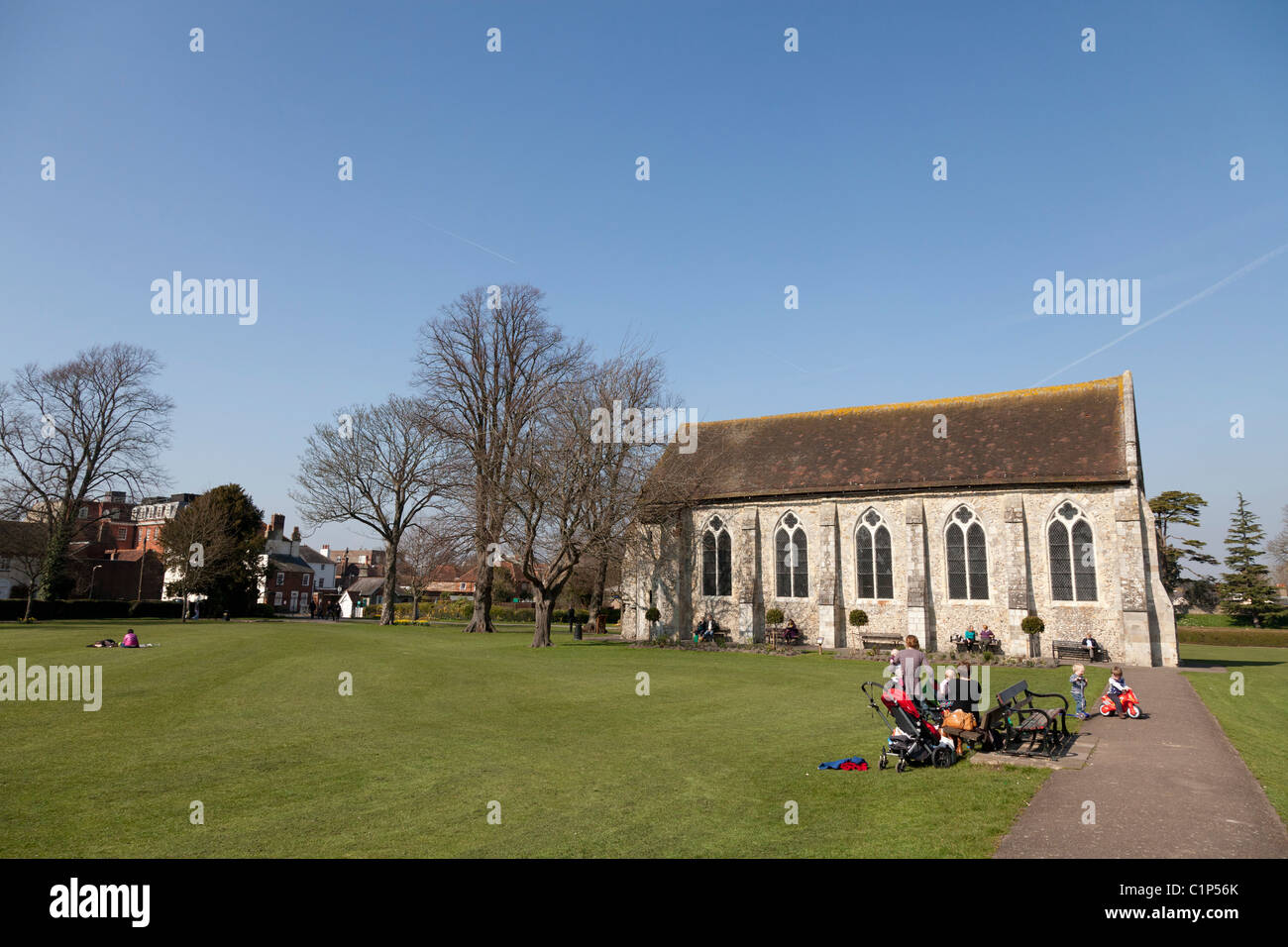 Family enjoying the spring sunshine in Priory park in Chichester city centre and the Guildhall Stock Photo