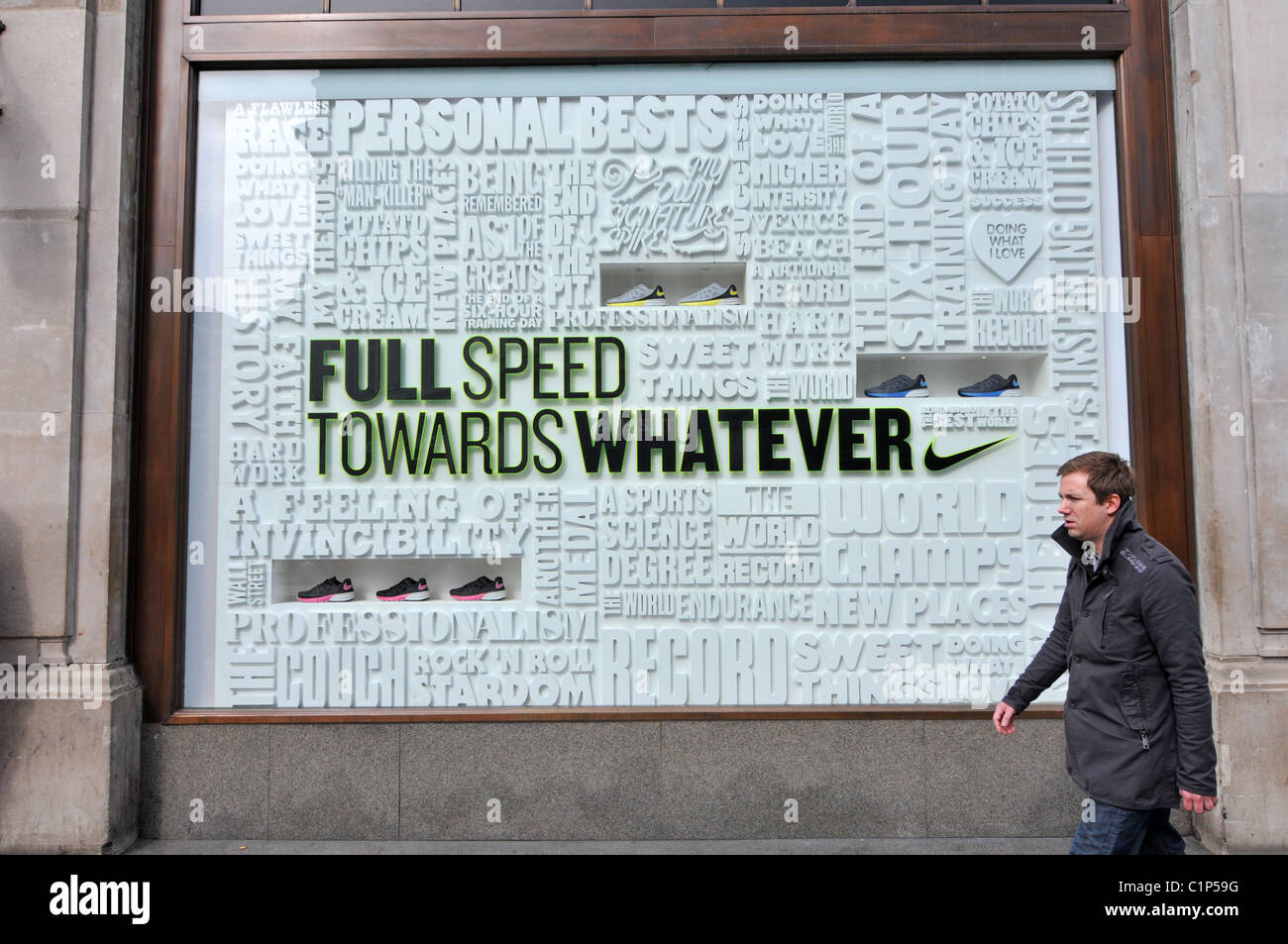 Nike store Oxford Circus advert shop window display slogan "full speed  towards whatever Stock Photo - Alamy