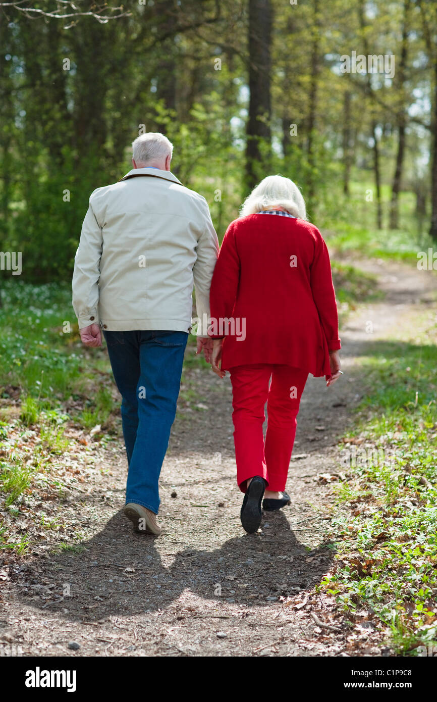Senior woman walking in park hi-res stock photography and images - Alamy