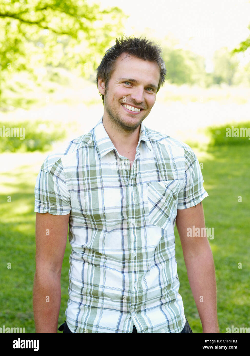 Young man looking at camera with smile Stock Photo - Alamy