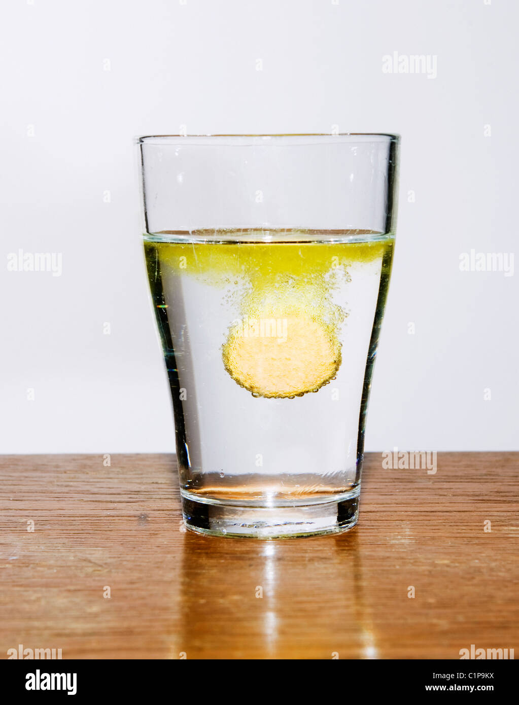 Tablet dissolving in glass of water Stock Photo