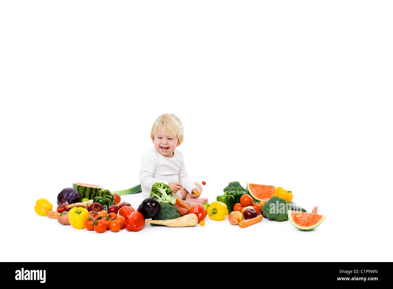 Studio shot of baby boy surrounded by fresh vegetables Stock Photo