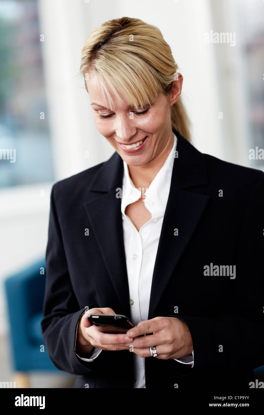 Businesswoman using smart phone Stock Photo