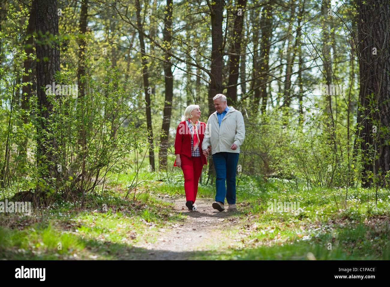 Senior couple walking in park Stock Photo - Alamy