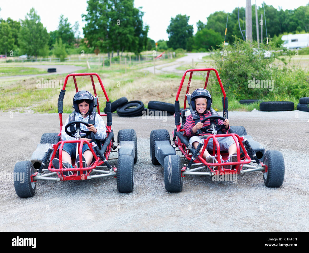 Portrait of two boys in go-carts on track Stock Photo