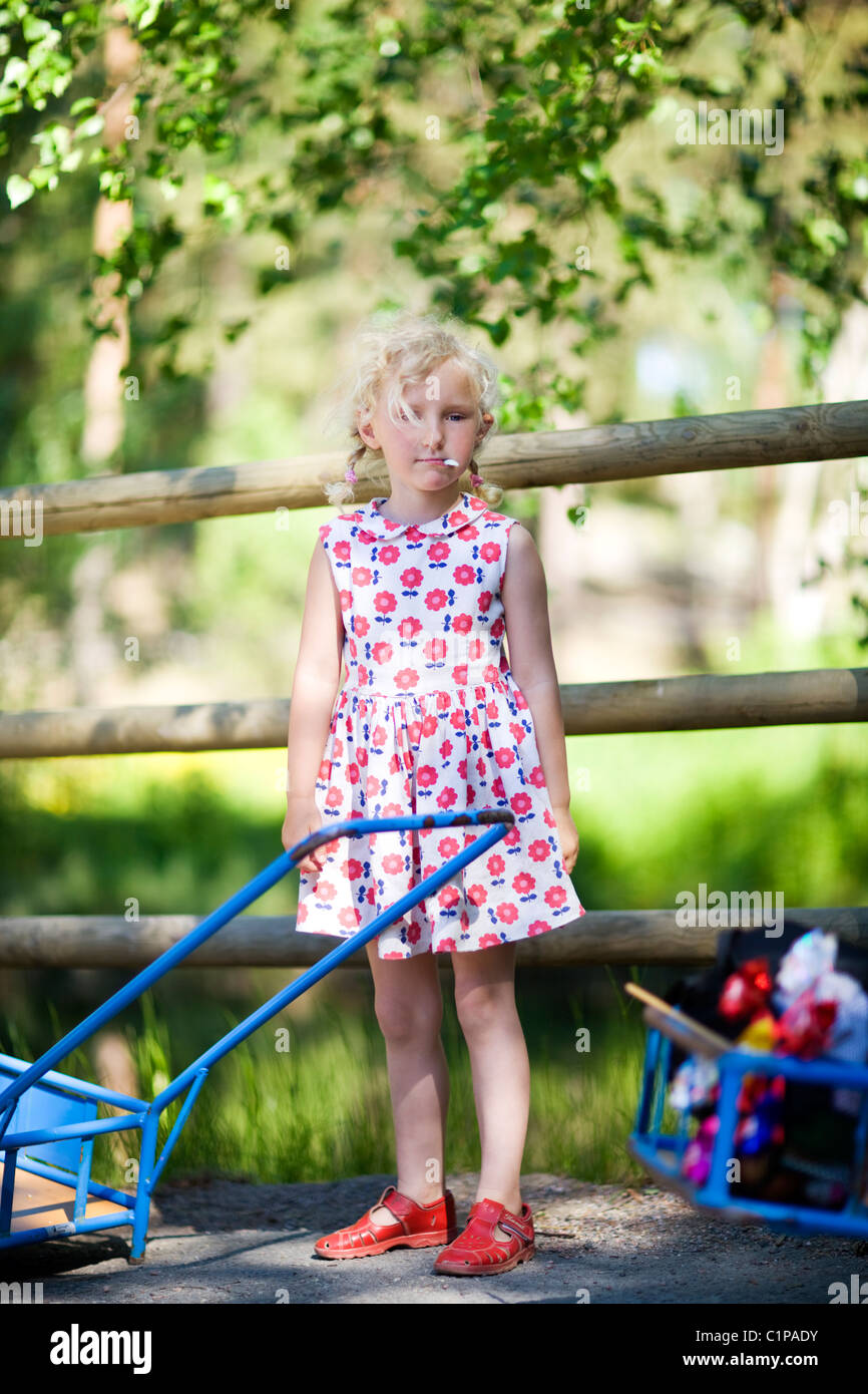 Portrait of girl standing by fence at zoo Stock Photo