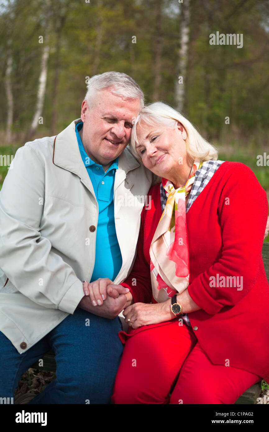 Senior couple sitting in park Stock Photo - Alamy