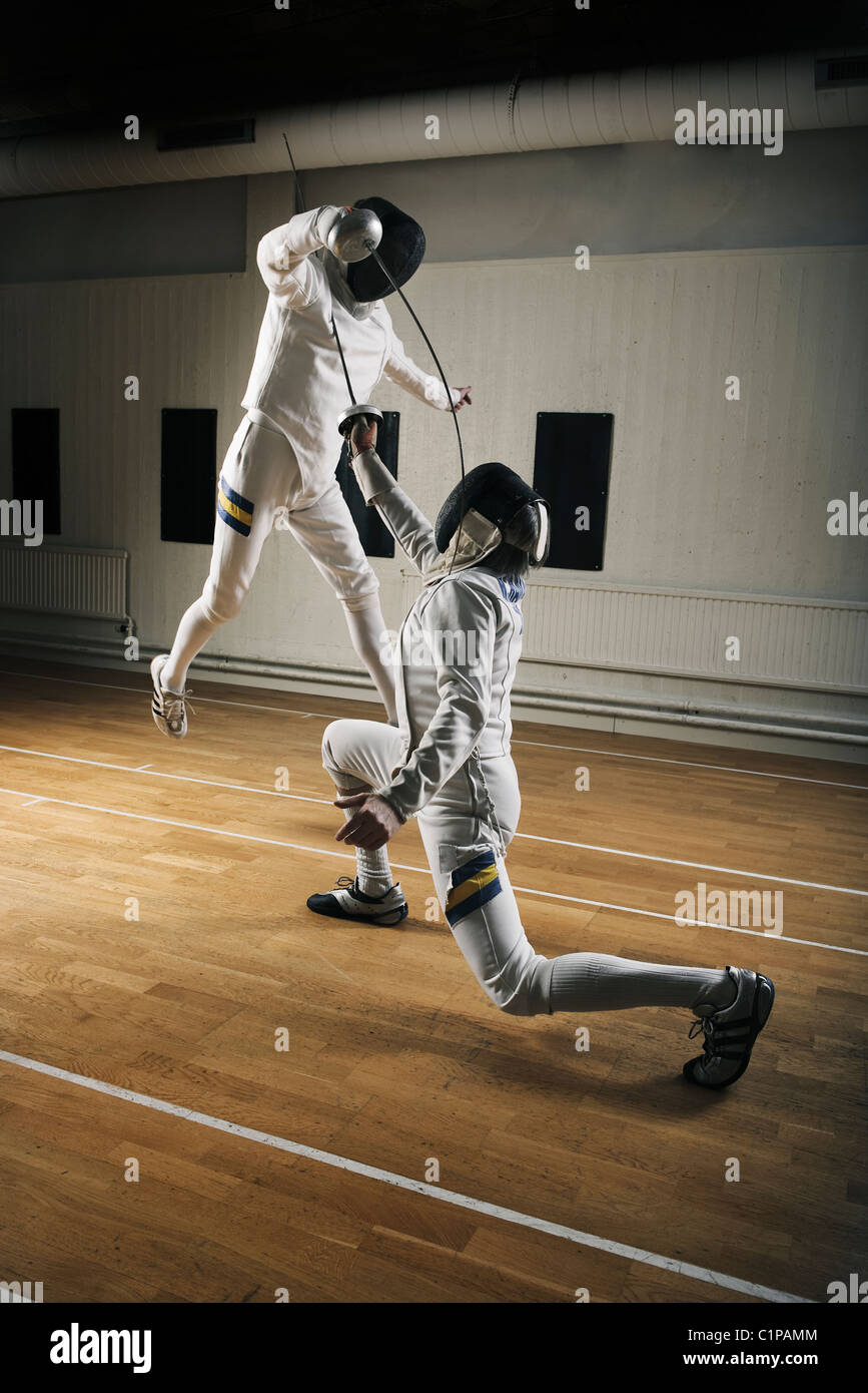 Two fencers in sports hall Stock Photo