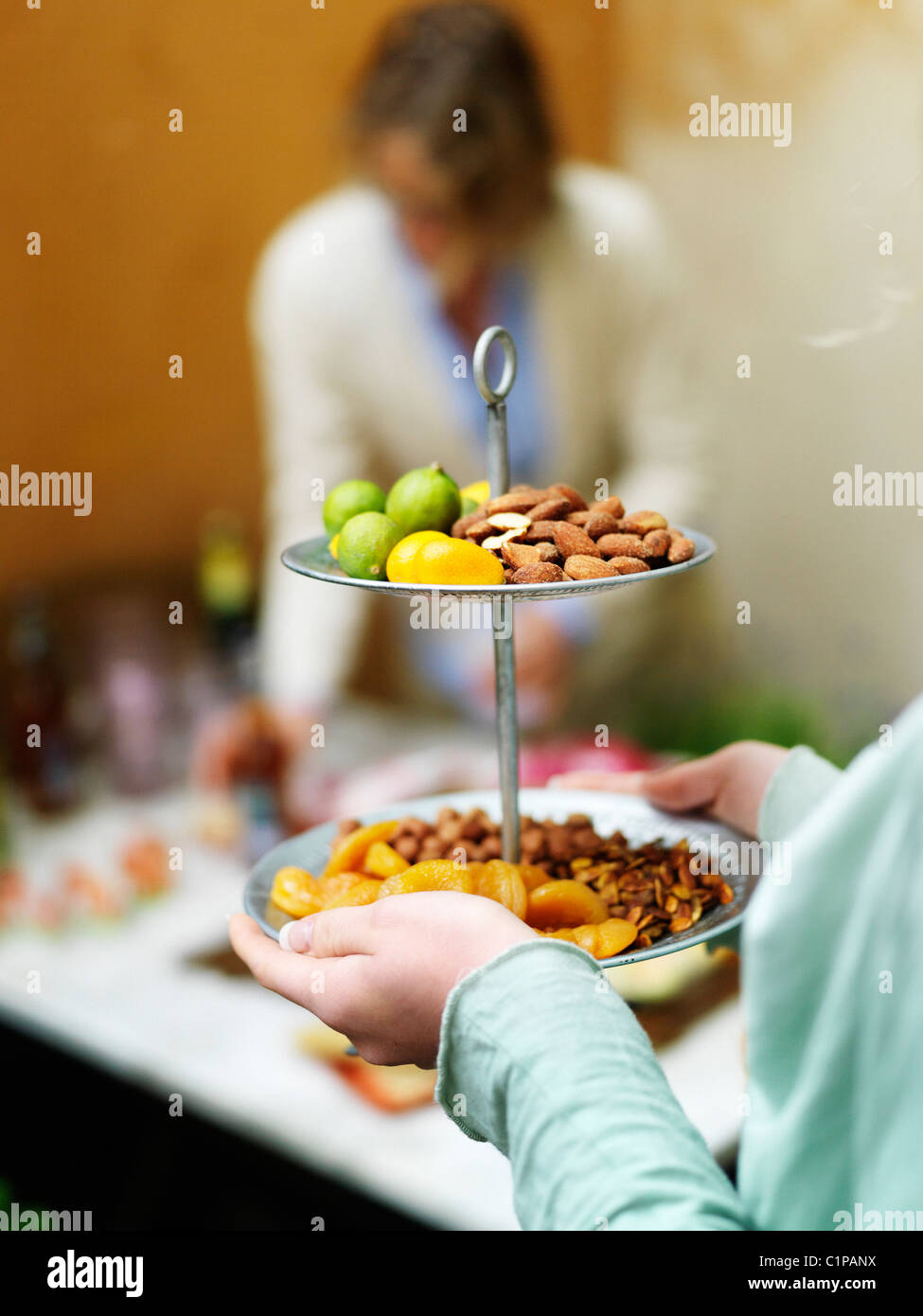 Close up of woman serving fruits and nuts Stock Photo