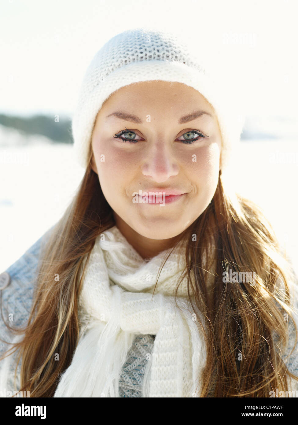 Portrait of young woman wearing white hat and white wooly scarf Stock ...