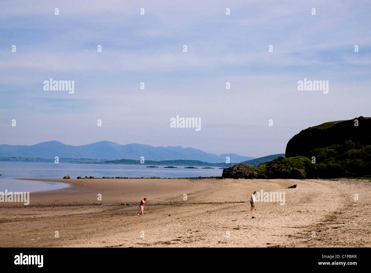 Scotland, Oban, people walking on beach Stock Photo