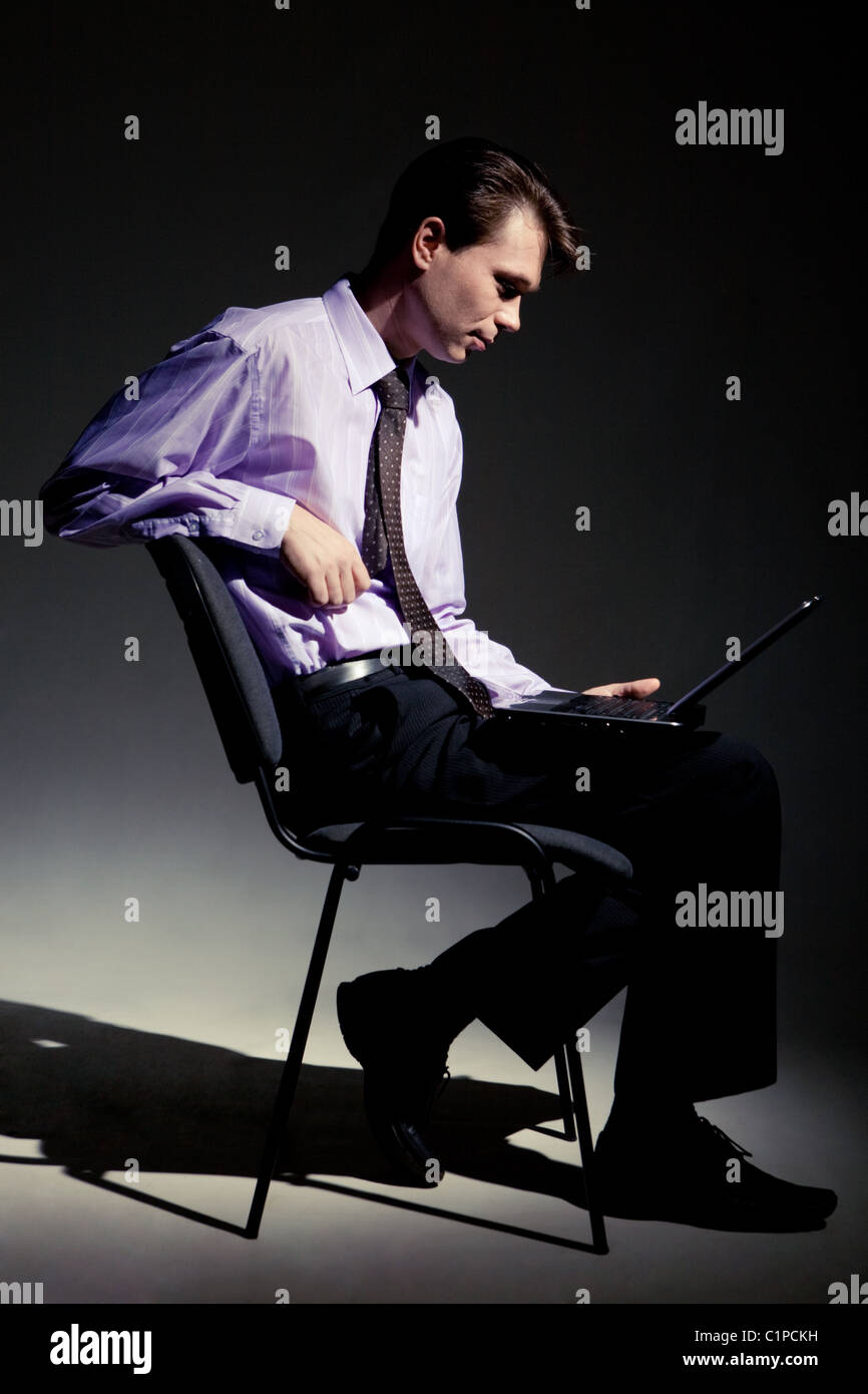 Guy sitting in chair laptop hi-res stock photography and images - Alamy