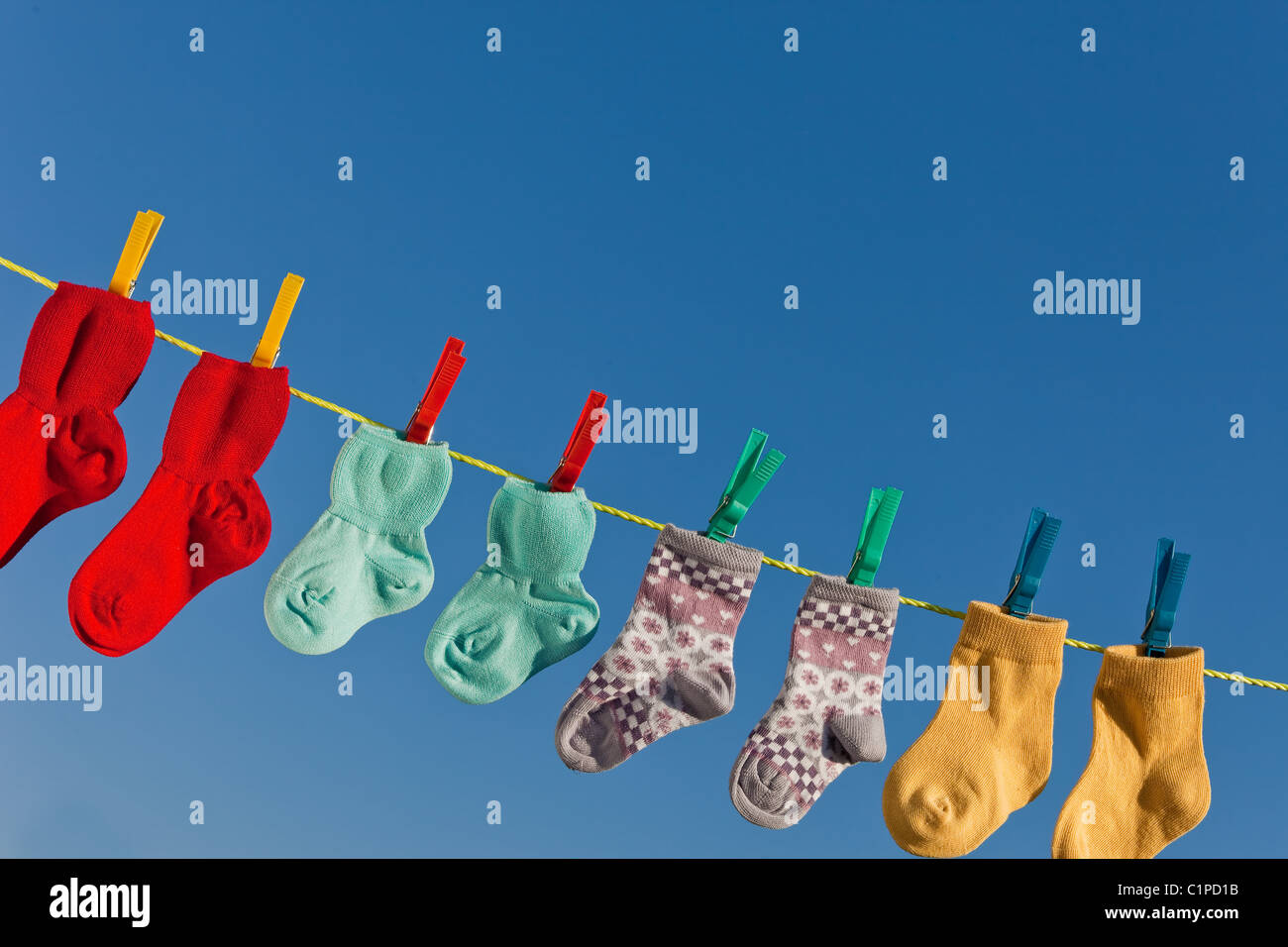 Baby socks on clothesline to dry Stock Photo Alamy
