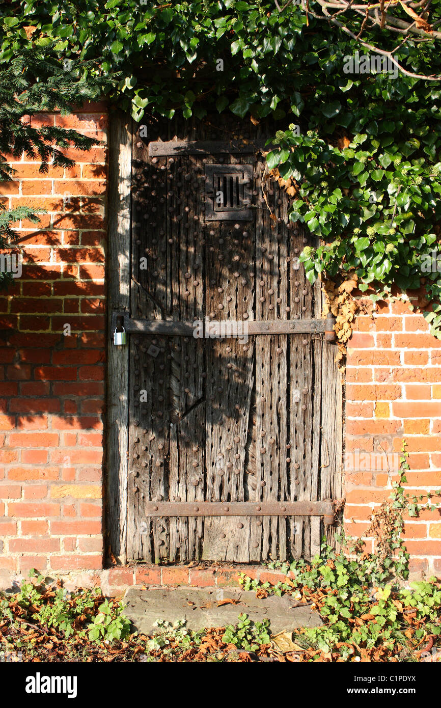 England, Kent, Yalding, closed wooden gate in brick wall Stock Photo