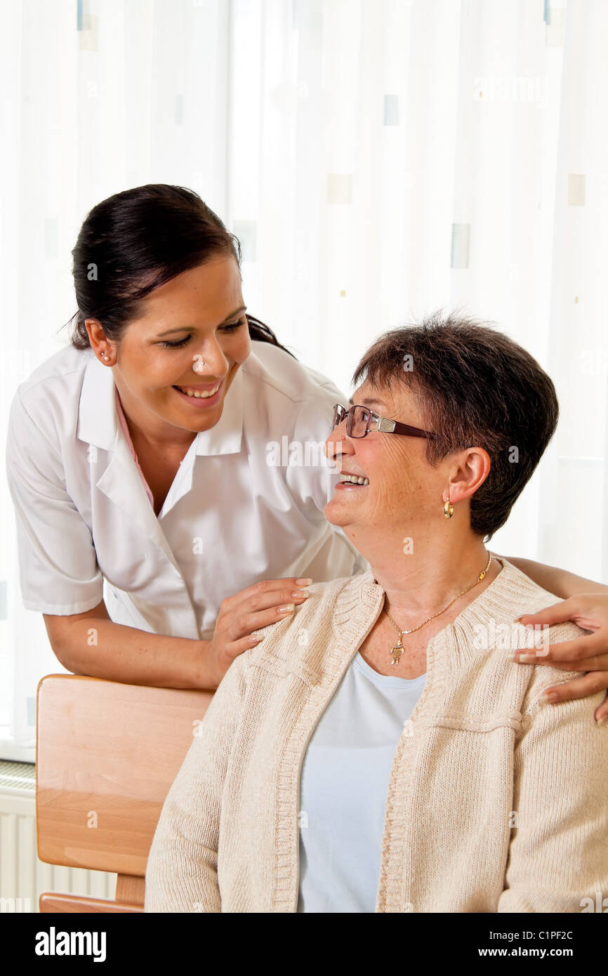 Nurse in aged care for the elderly in nursing homes Stock Photo