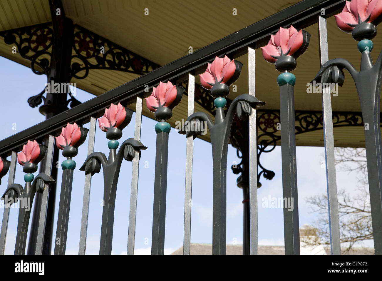 England, Derbyshire, Buxton, floral wrought-iron bandstand railings in Pavilion Gardens Stock Photo