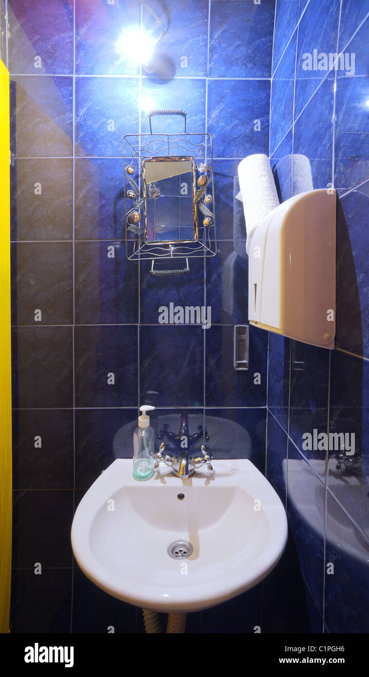 Interior of a small restaurant toilet, simple and blue.  Stock Photo