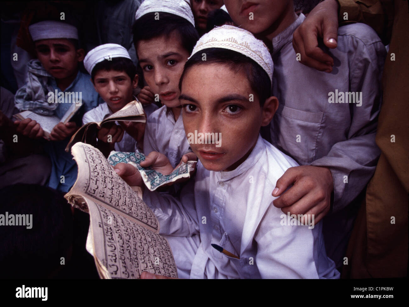 Young Muslim boys recite verses in Arabic from the Quran at a Peshawar, Pakistan madrassa, or religious school. Stock Photo