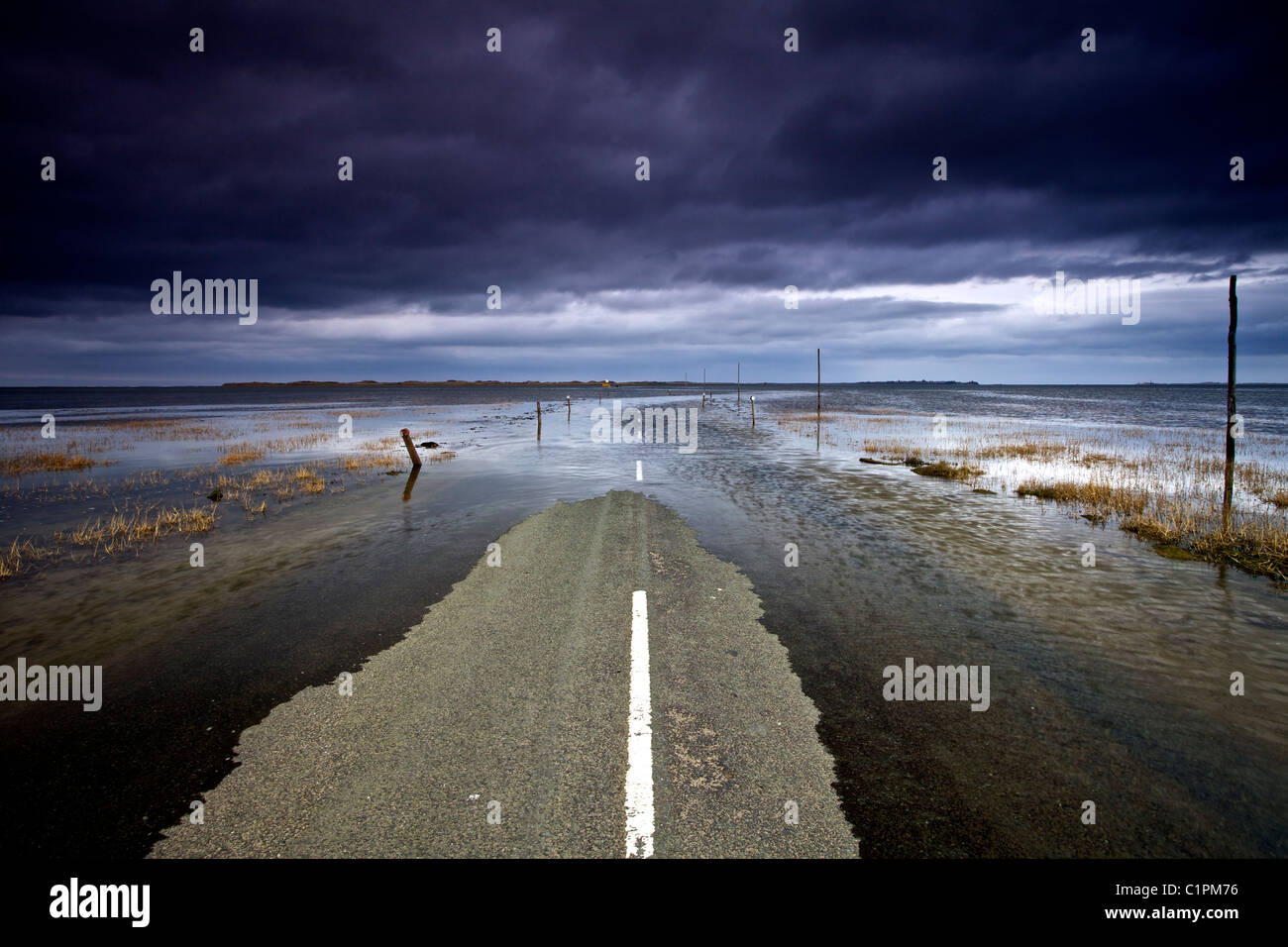 Lindisfarne causeway flooded by the incoming tide. Holy Island. Stock Photo