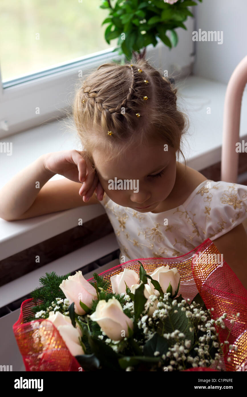 The sad girl with a bunch of flowers Stock Photo - Alamy