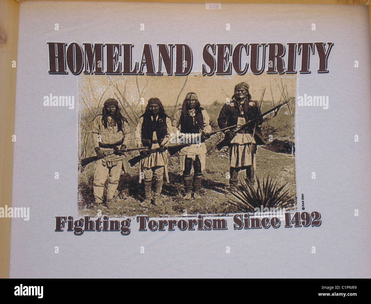 Design on a quirky T-Shirt in shop window, Silverton, Colorado, USA, showing four native American Indians with rifles. Stock Photo