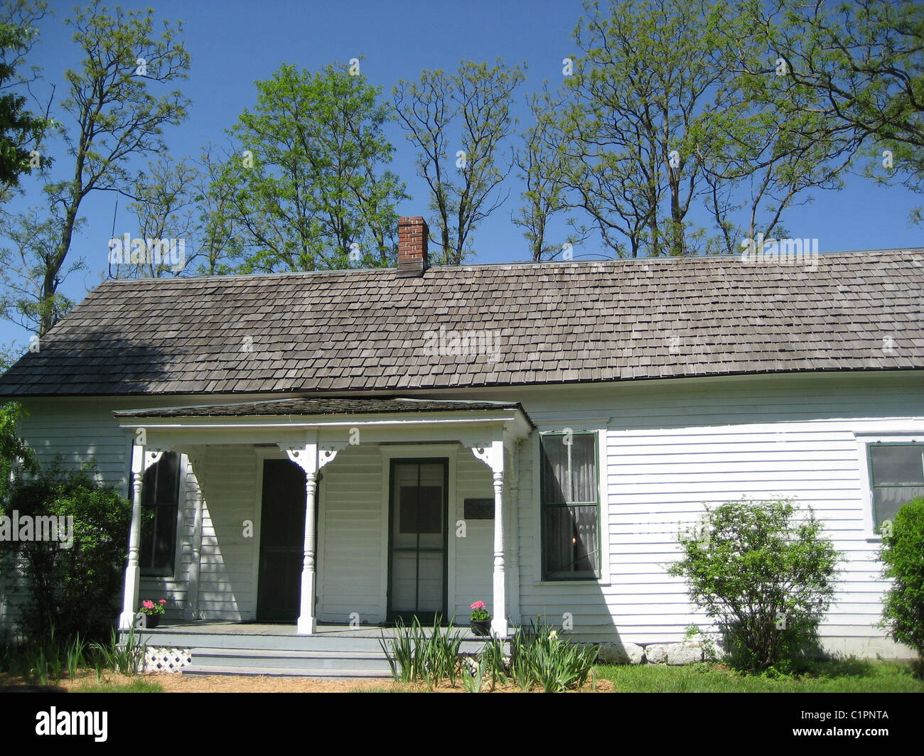 USA. Exterior view of the Jesse James Farm Museum, Kearney, Missouri, showing covered porch and door. Stock Photo