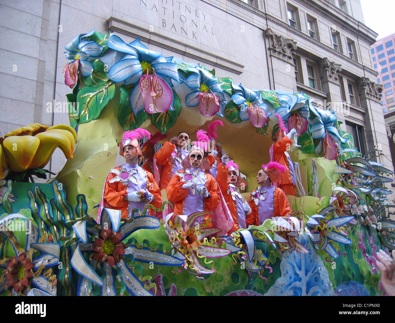People in brightly coloured costumes on a float at the traditional Mardi Gras festival, New Orleans, USA. Stock Photo