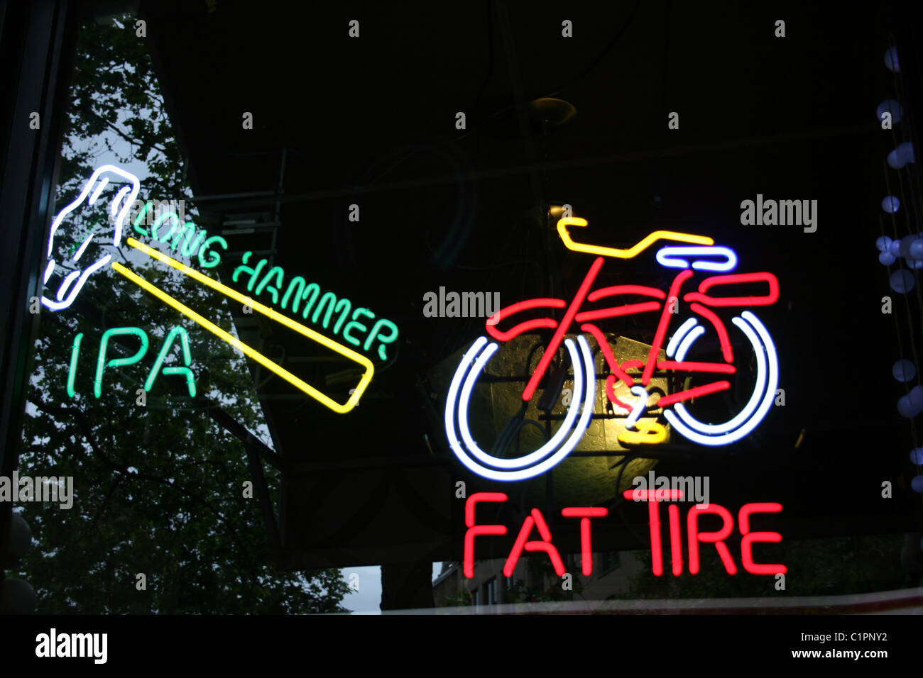 Seattle, USA. Two neon beer signs, promoting beer brands; Long hammer IPA and Fat Tire. Stock Photo