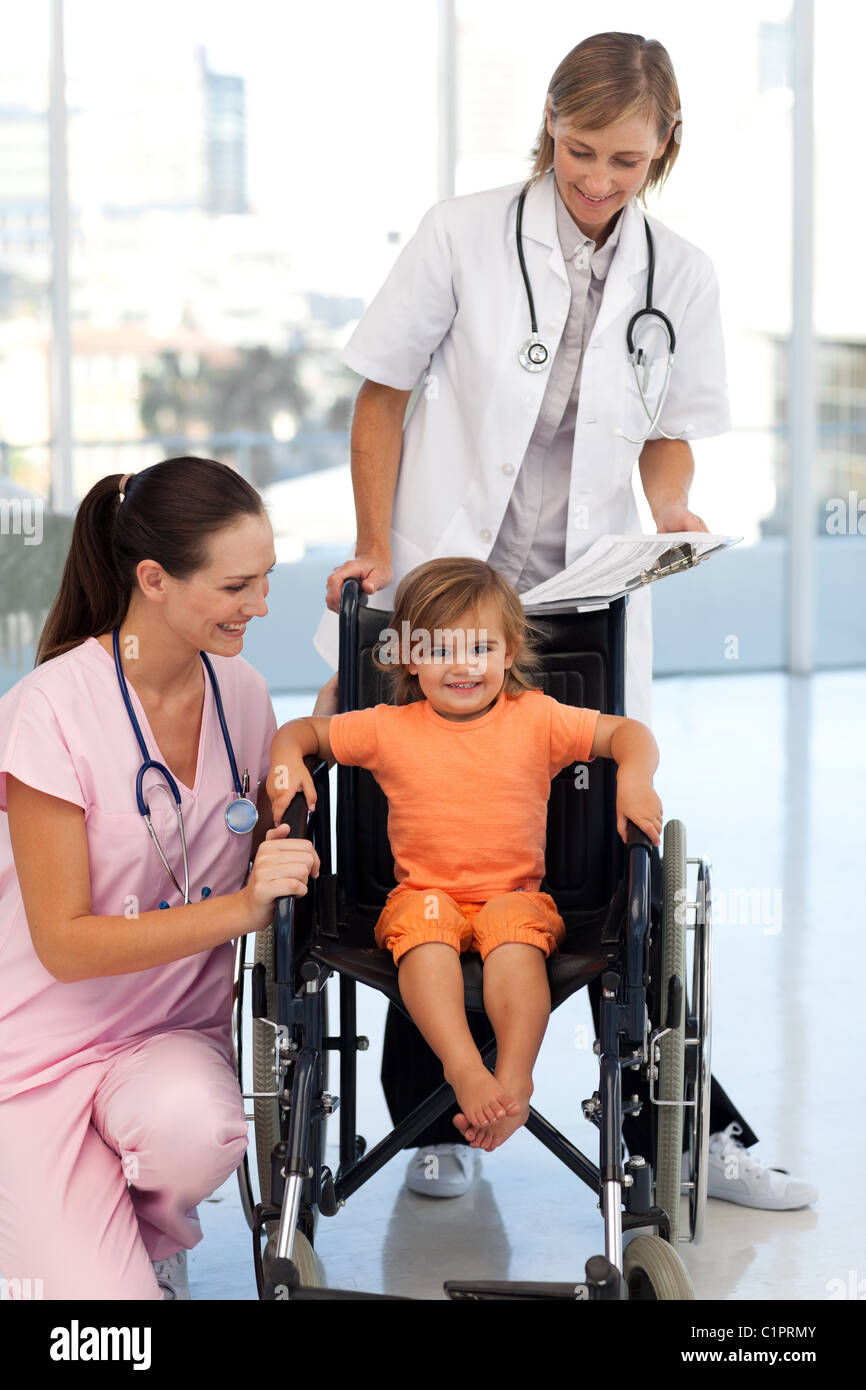 Baby girl sitting in a wheelchair Stock Photo Alamy