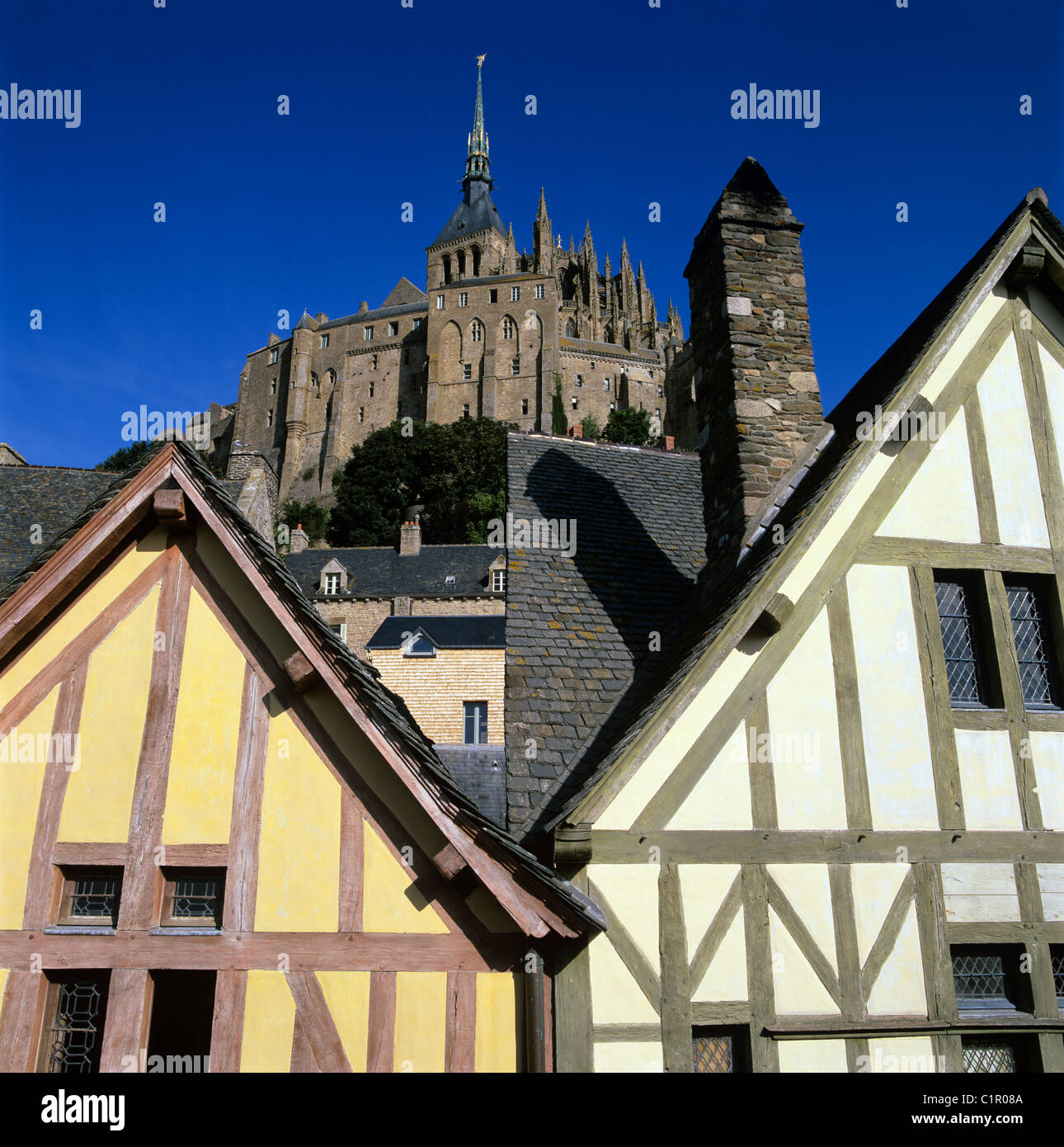 Timber framed buildings and Mont St Michel Abbey Stock Photo